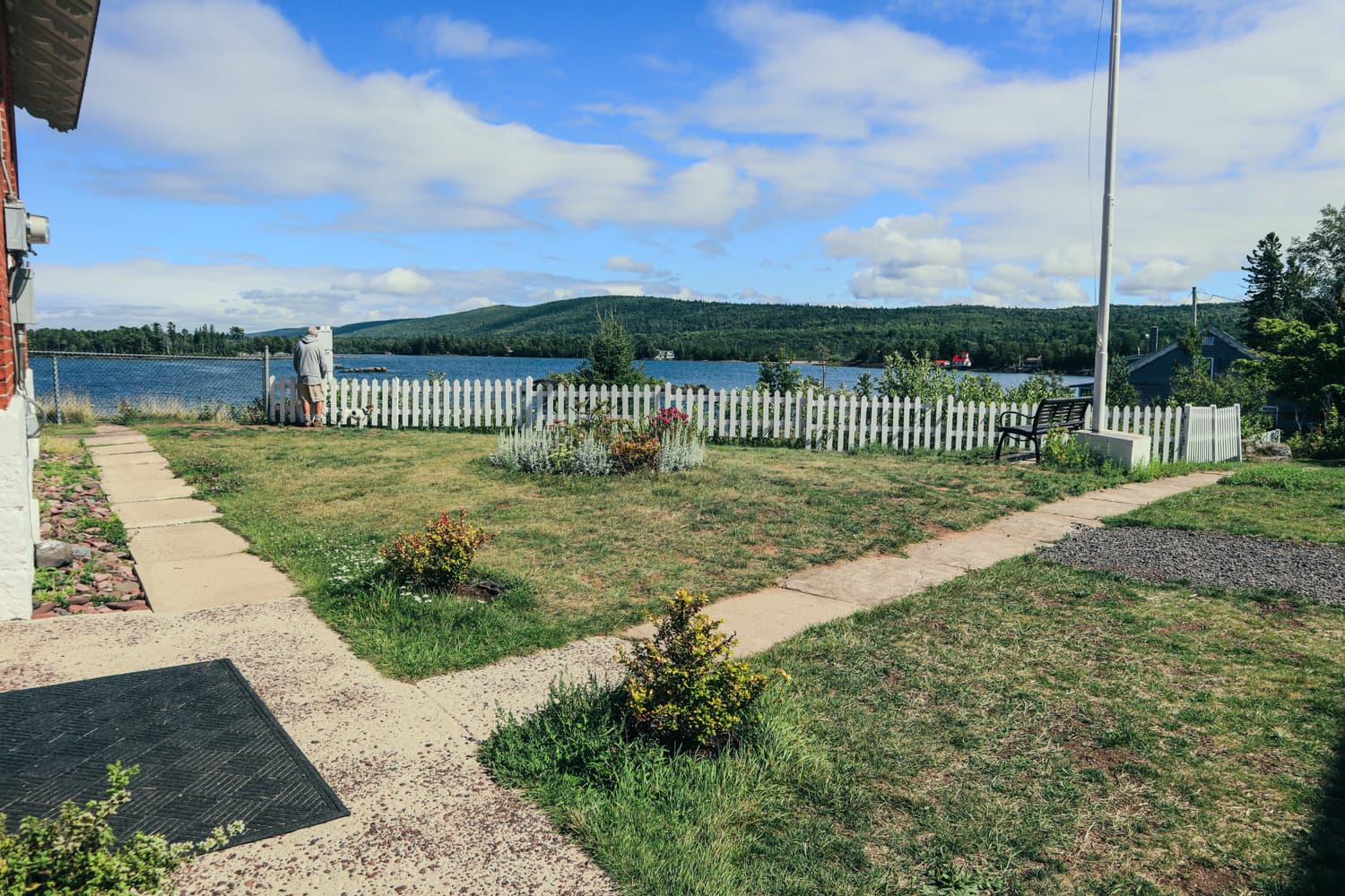 The keeper's quarters lawn and white picket fence overlooking Eagle Harbor