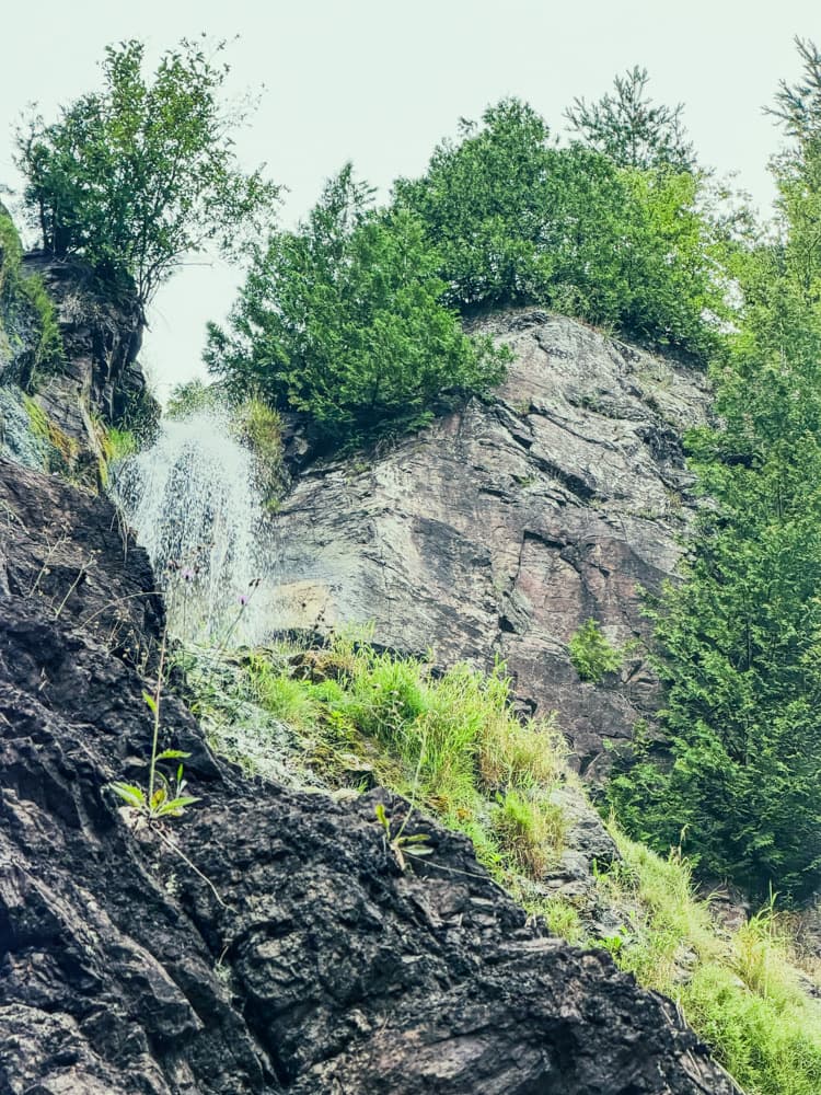 Looking up at Houghton Douglass Falls and the rock walls of the gorge from near the bottom