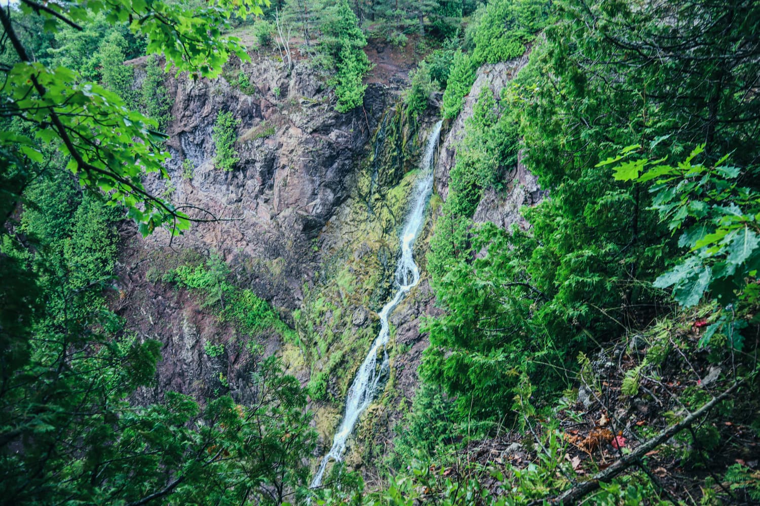 Houghton Douglass Falls dropping through a narrow, forested rock gorge on Hammell Creek in the Keweenaw Peninsula