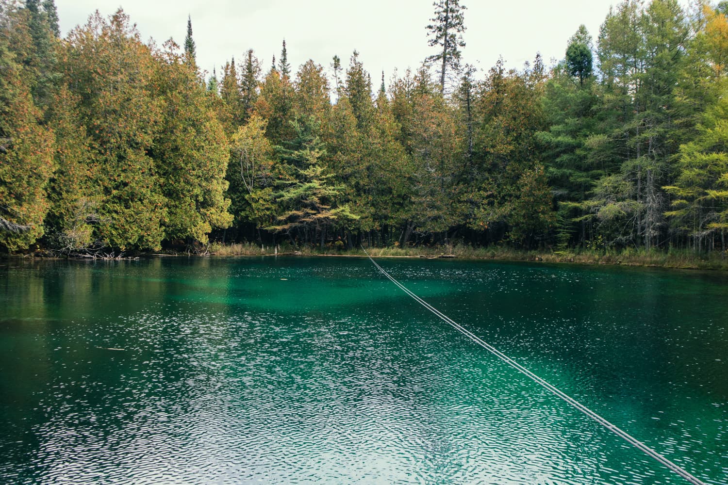 The cable the hand-cranked raft follows across the turquoise water of Kitch-iti-kipi