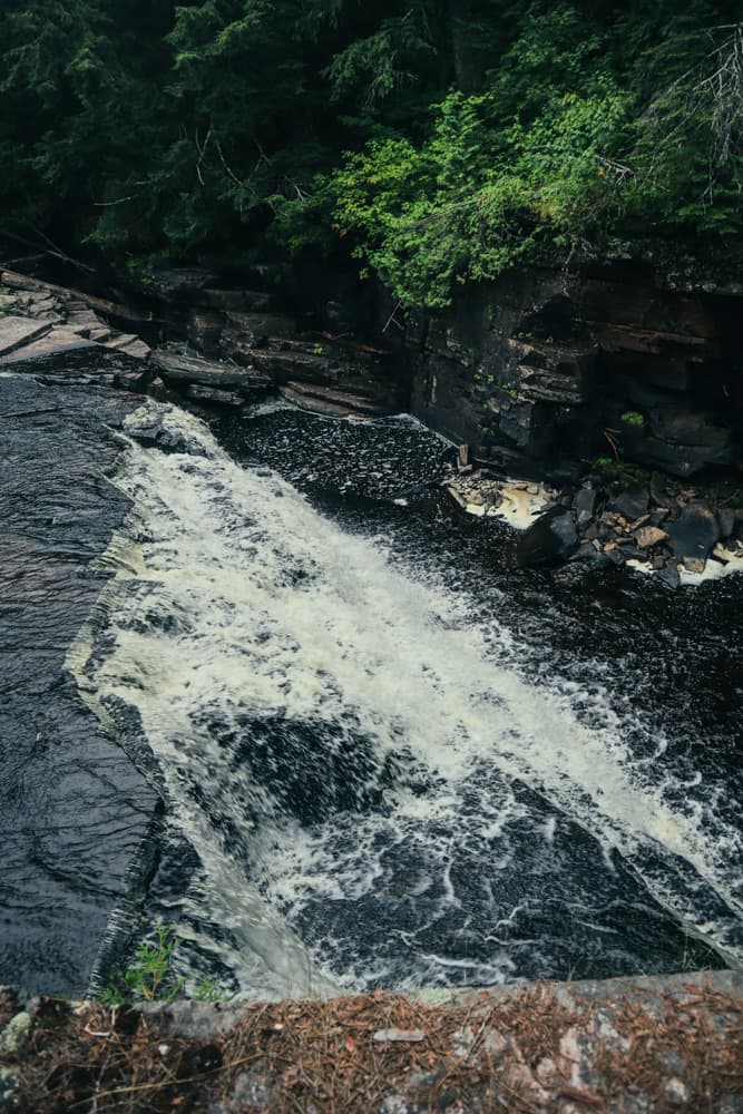 A smaller cascade pouring over dark rock along the Sturgeon River near Canyon Falls
